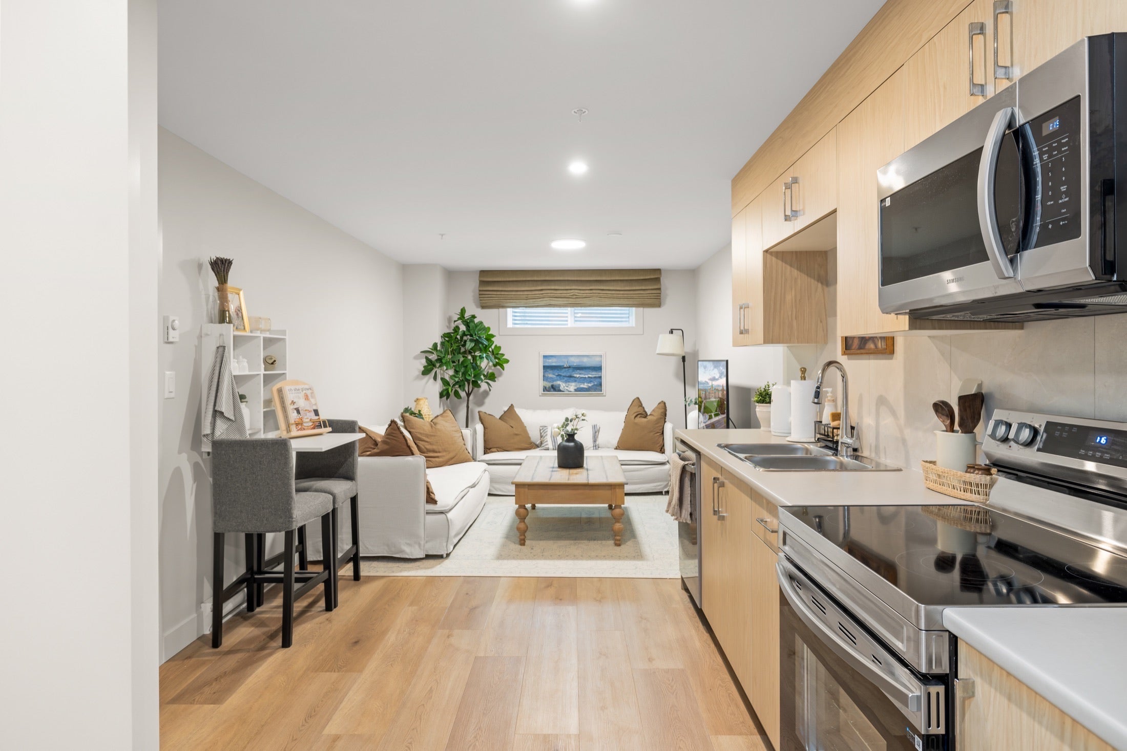 Full kitchen with stainless steel appliances and dining space